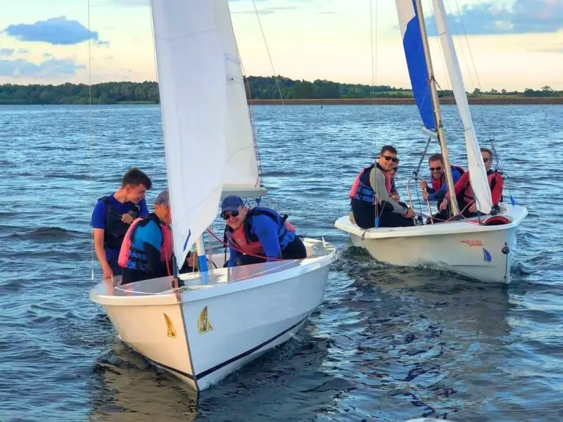 2 boats with sailors