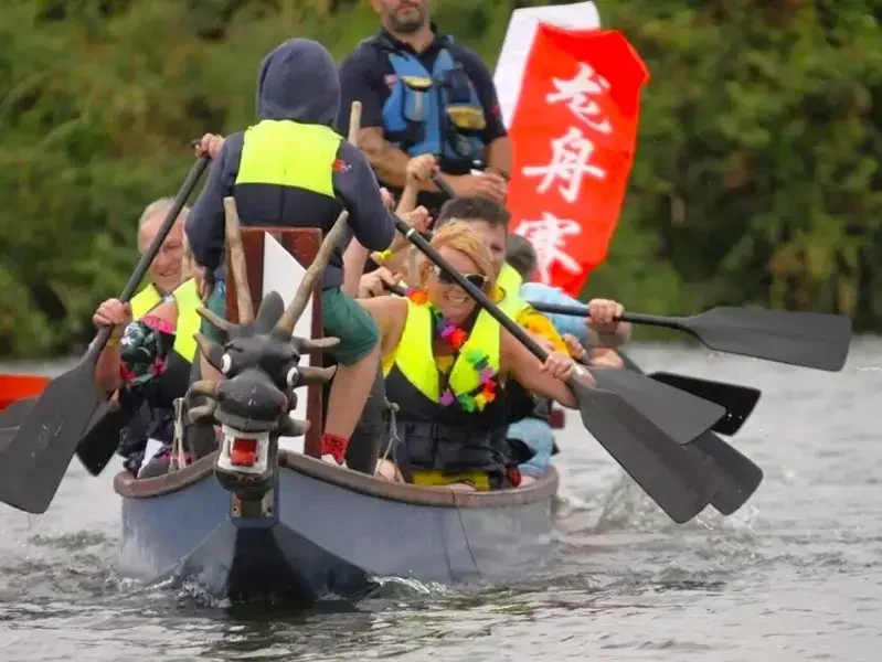 A dragon boat being rowed by a team