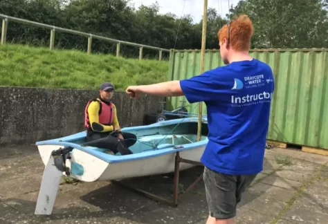 A sailing instructor teaching a student at Draycote Water