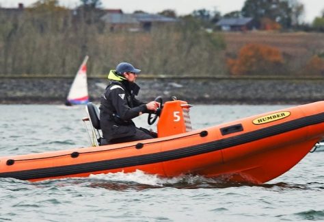Rescue staff driving a RIB at a sailing event at Draycote Water