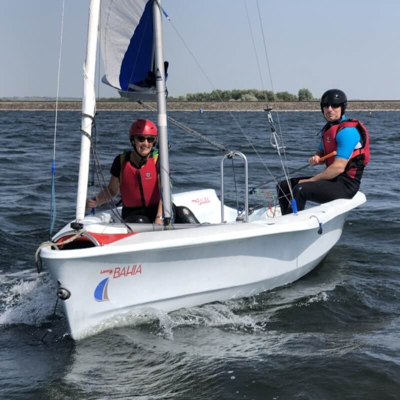 a man and a woman sailing a dinghy on their sailing course at Draycote Water