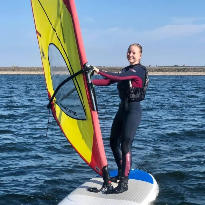 A woman learning to windsurf at Draycote Water