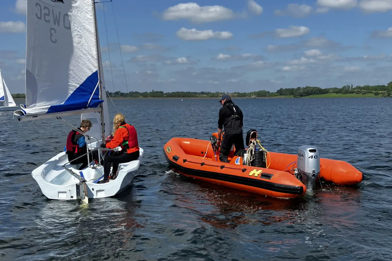 A dinghy instructor running a sailing course