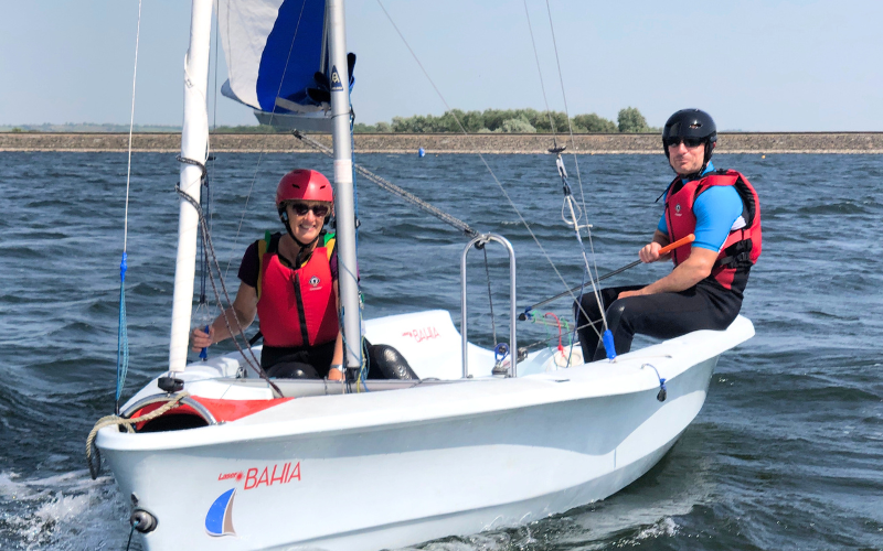 a man and a woman sailing a dinghy on their sailing course at Draycote Water